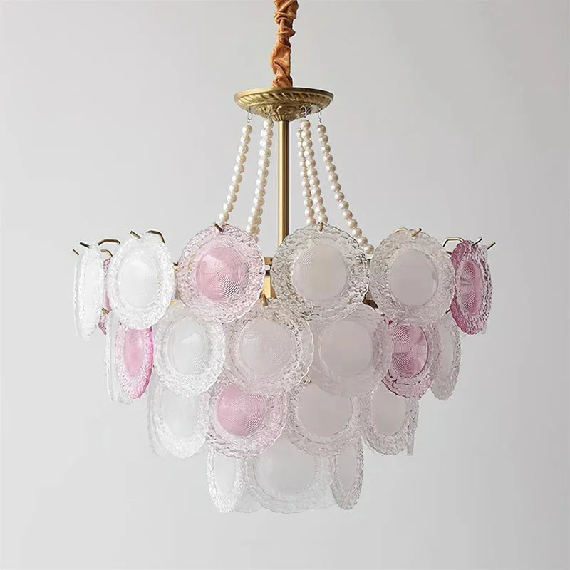 Chandelier with pink and clear glass shades on a light gray background