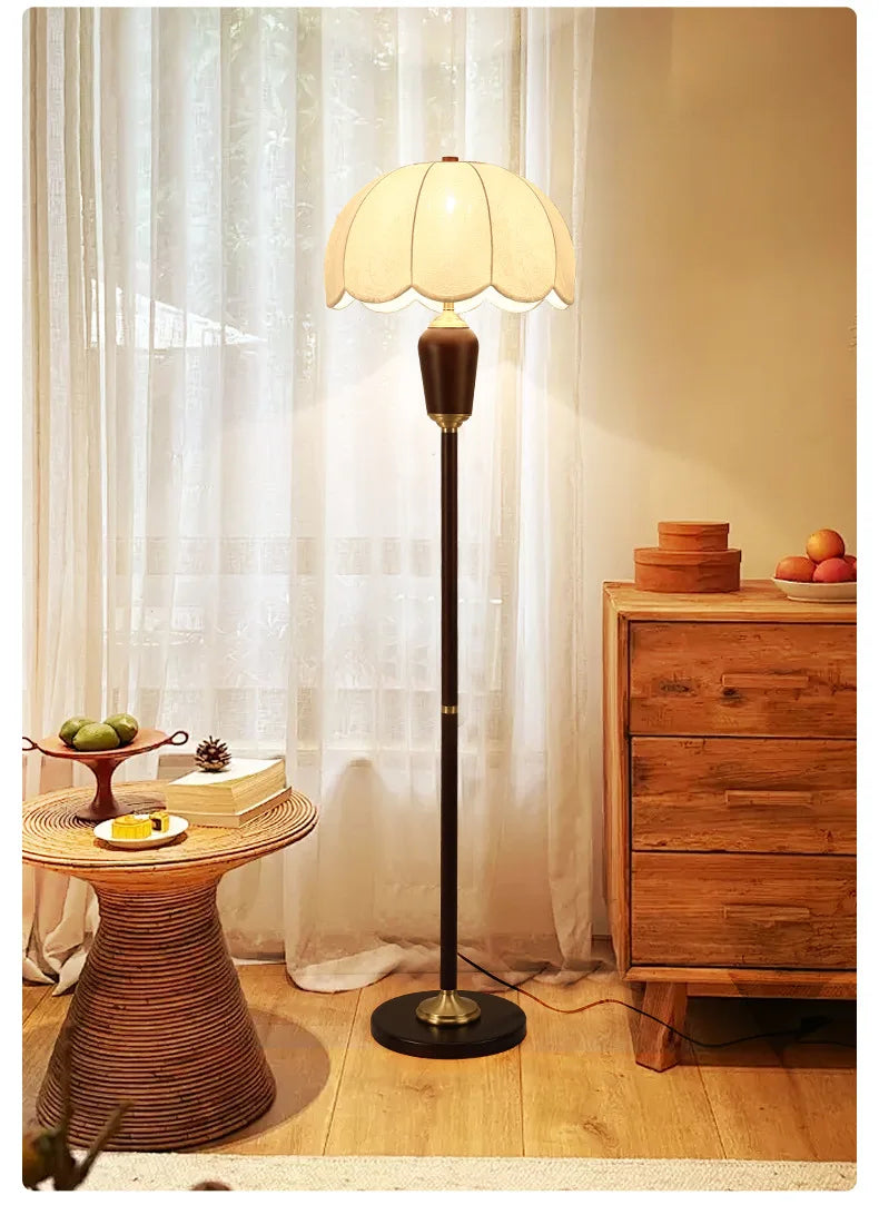 Floor lamp in a room with wooden furniture and decorative items.