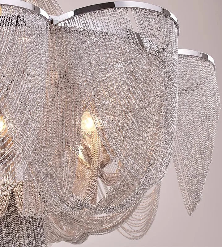 Close-up of a chandelier with crystal strands on a neutral background