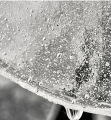 Extreme close-up showing the bubble and textured details on a clear glass disc of a pendant light.