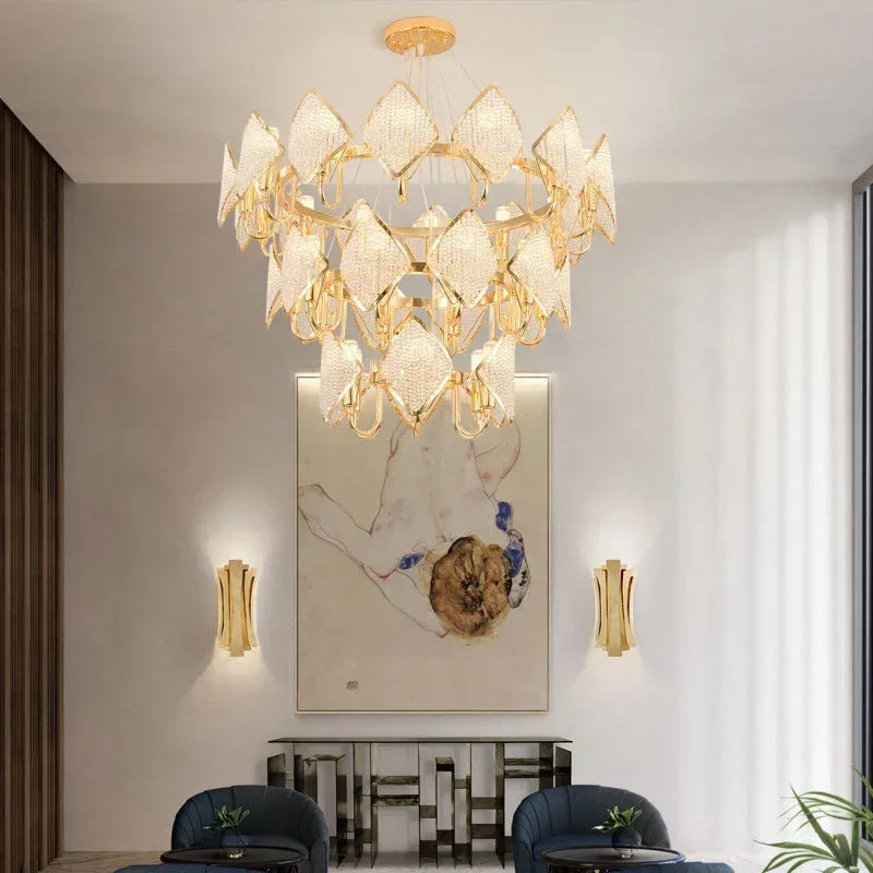 A grand gold crystal chandelier with multiple tiers suspended in a well-lit room.