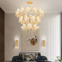 A grand gold crystal chandelier with multiple tiers suspended in a well-lit room.