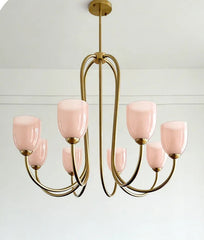 A close-up detail of a white glass shade on a gold-toned fixture.