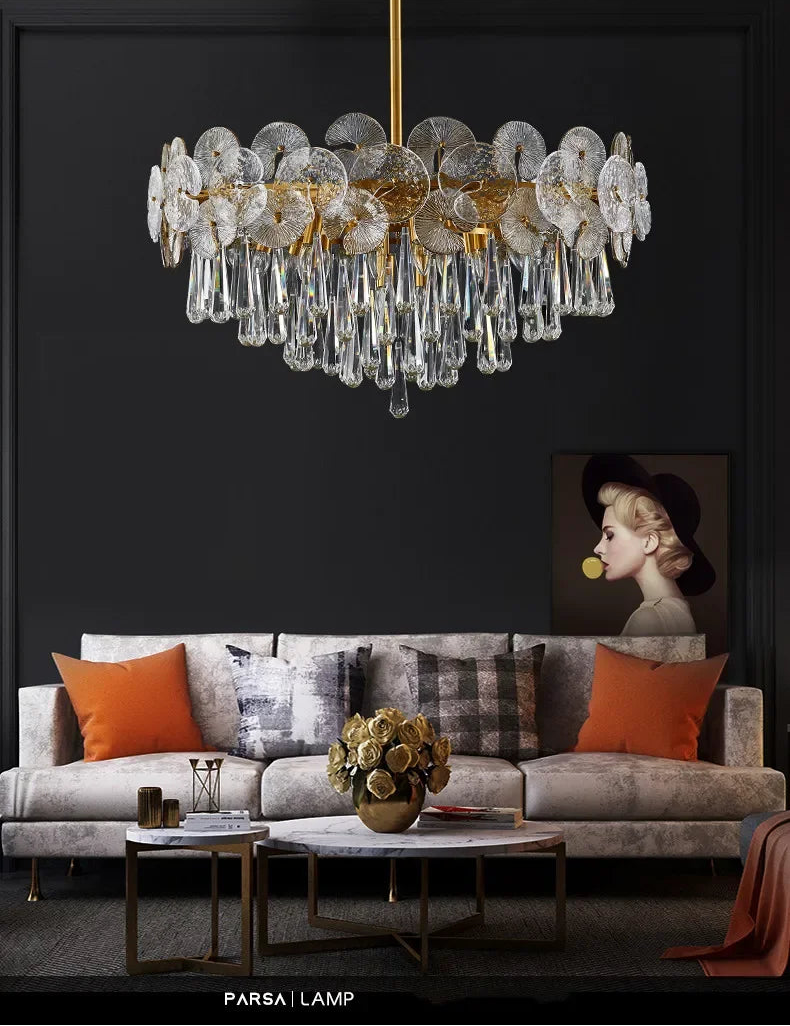 Luxury chandelier hanging above a living room with a sofa and coffee table.