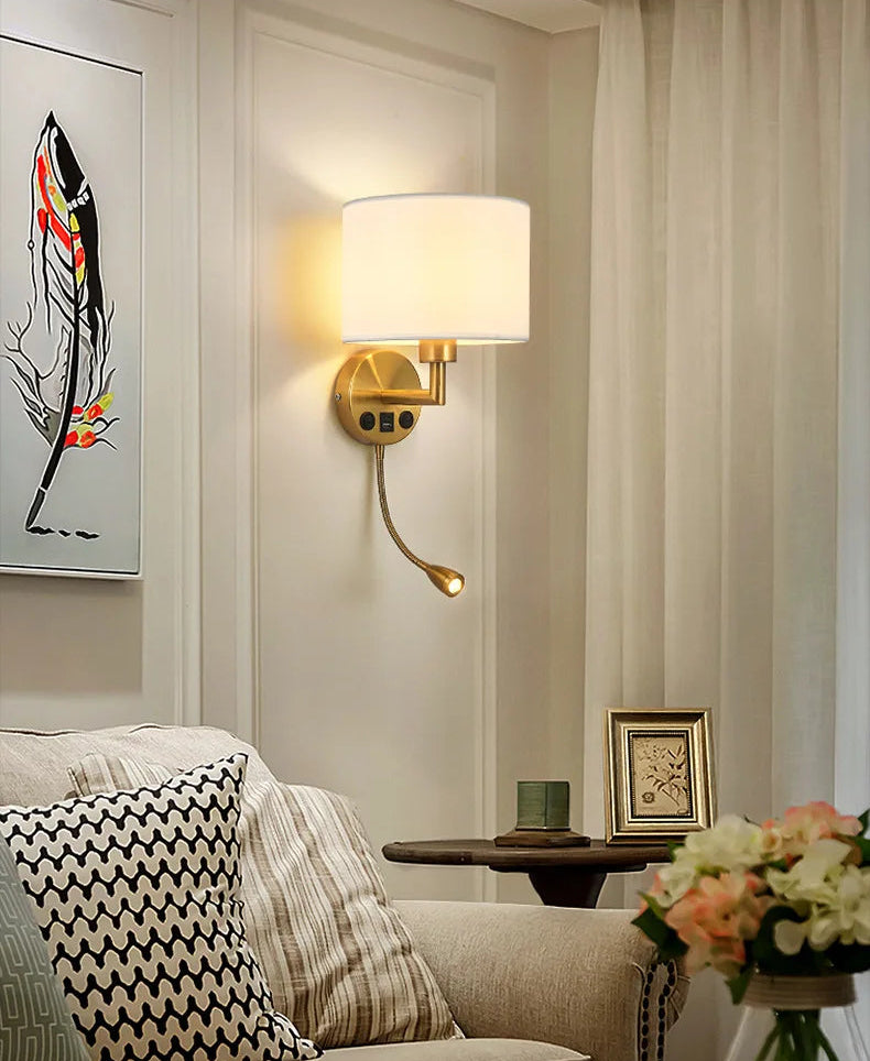 Living room with a wall lamp, sofa, and decorative elements.