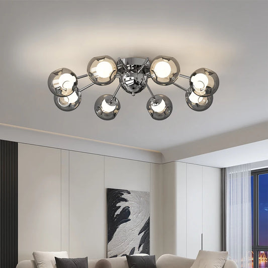 Close-up of a polished chrome starburst chandelier, showing the detail of the metal arms and glass shades.