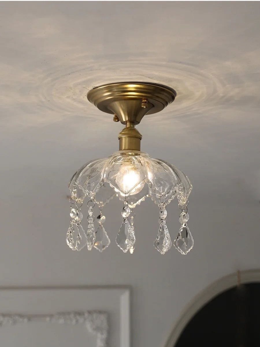 Ceiling light fixture with crystal accents on a neutral ceiling