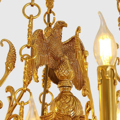 Close-up of the gold flying eagle detail on a candelabra crystal chandelier.