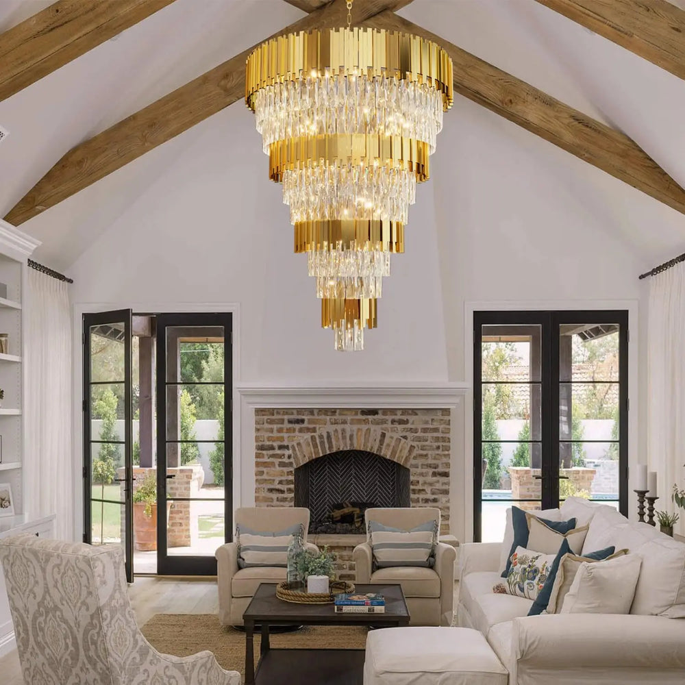 Luxurious living room with a gold chandelier, white sofa, and armchair.