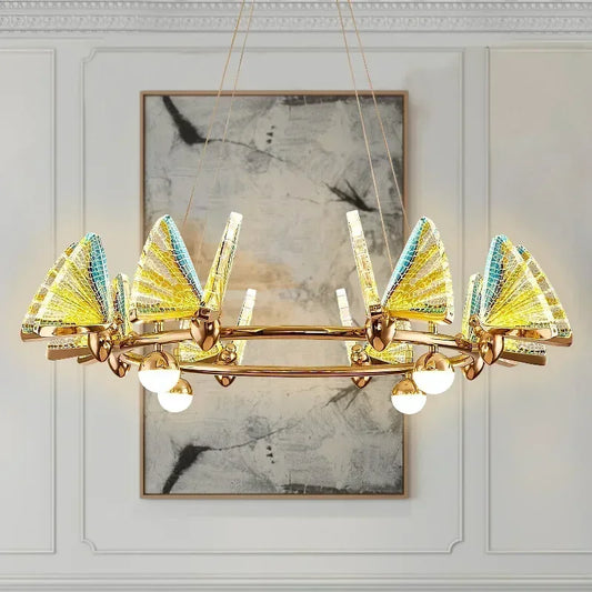Gold ring chandelier with translucent yellow and blue butterfly-shaped shades and globe lights.
