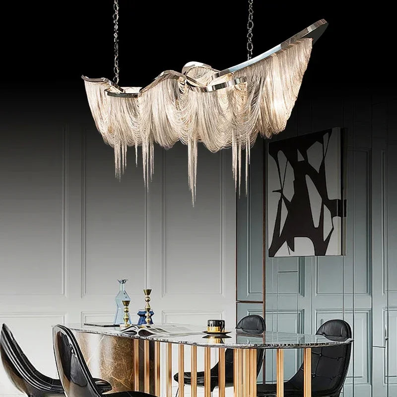 Chrome aluminum chain tassel pendant light cascading over a modern dining table.