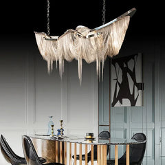 Chrome aluminum chain tassel pendant light cascading over a modern dining table.