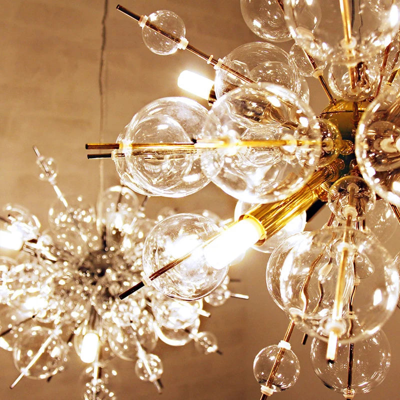 Chandelier with clear glass bubbles and gold accents on a beige background