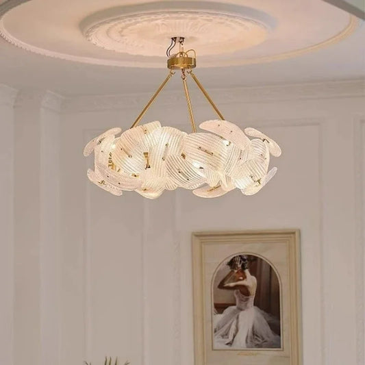 Close-up of the intricate woven texture and polished gold frame of the floral pendant light.