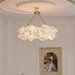 Close-up of the intricate woven texture and polished gold frame of the floral pendant light.