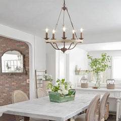 Dining room with a chandelier, table, chairs, and decorative elements.