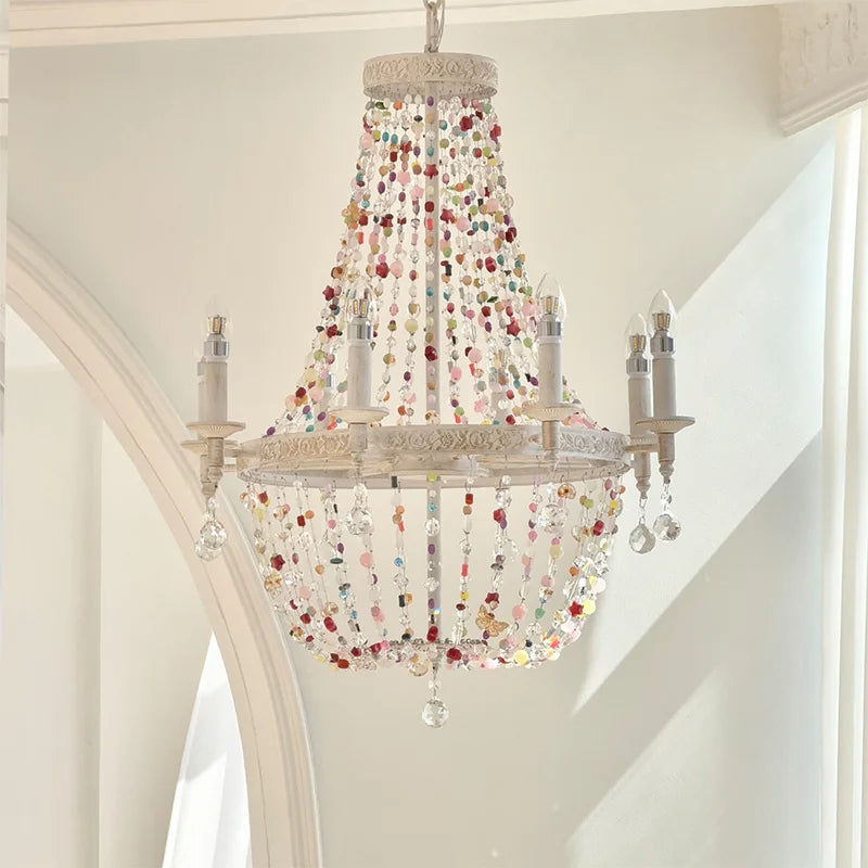 White multi-arm chandelier with cascading colorful beads and clear crystals, hanging from a white ceiling.