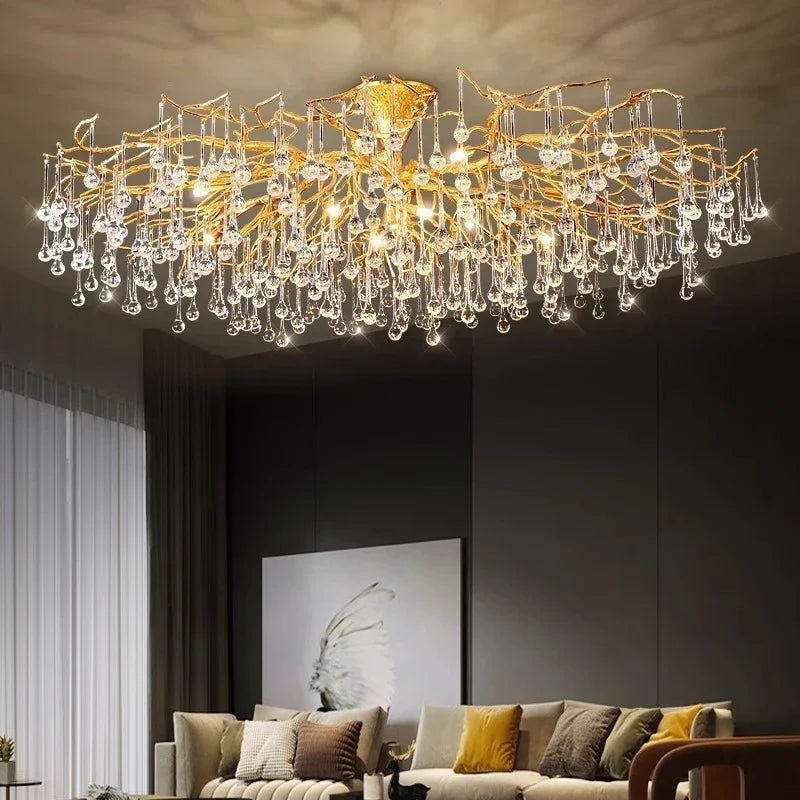 A large gold branch crystal chandelier suspended from a white ceiling, showcasing its intricate design.