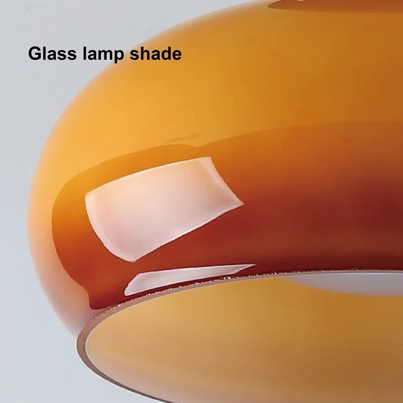 Close-up of a glass lamp shade with a white label on a light gray background