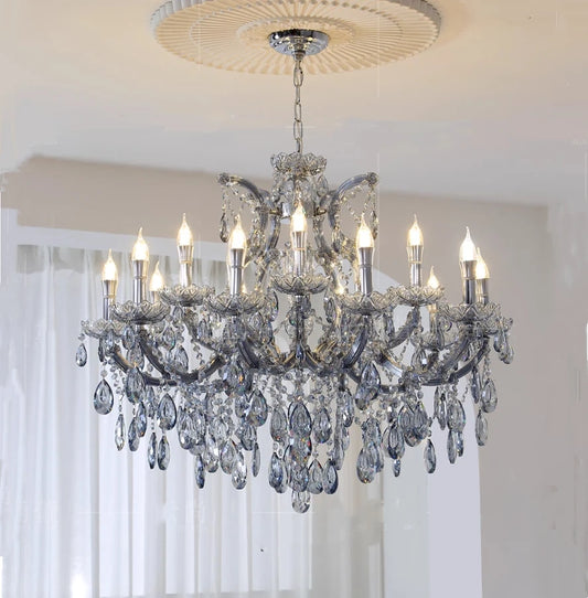Close-up view of the intricate crystal detailing on a grey metal candelabra chandelier.