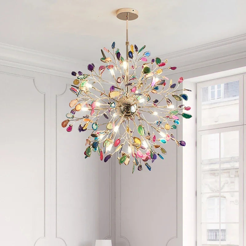 A multi-colored agate slice floral chandelier with a gold frame in a well-lit room.