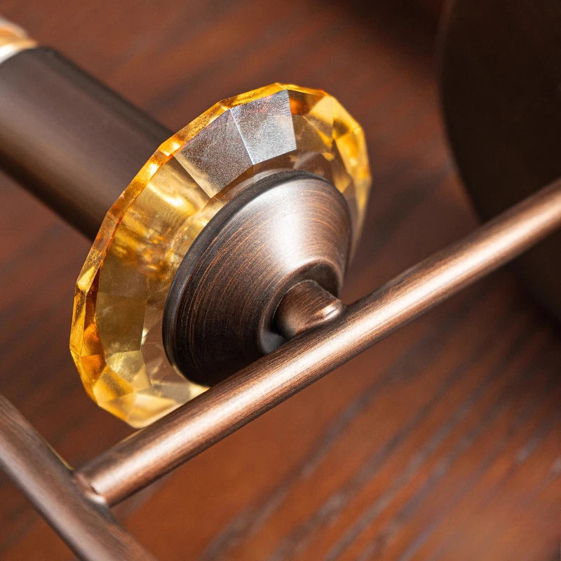 Close-up of a decorative doorknob with a gold and bronze finish on a wooden door.