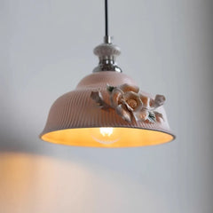 Decorative ceiling light with floral design on a plain background