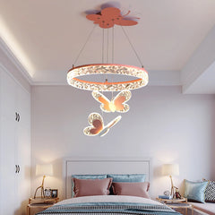 A pink crystal ring pendant light with butterfly accents hanging above a bed in a child's bedroom.