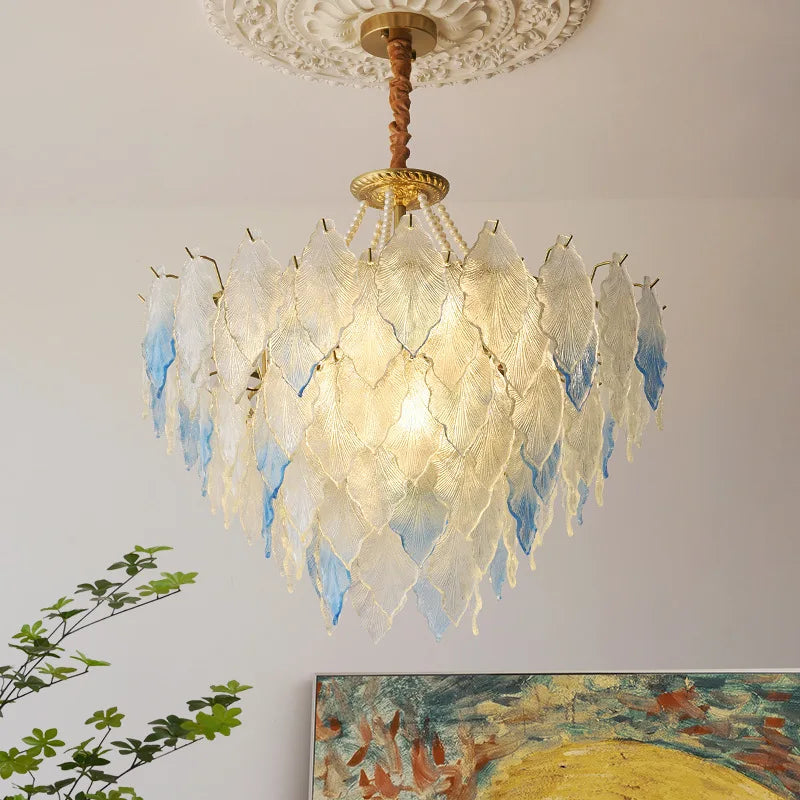 Decorative chandelier with leaf-like design on a neutral wall background
