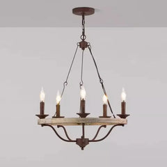 Vintage-style chandelier with five candle-like lights on a plain background