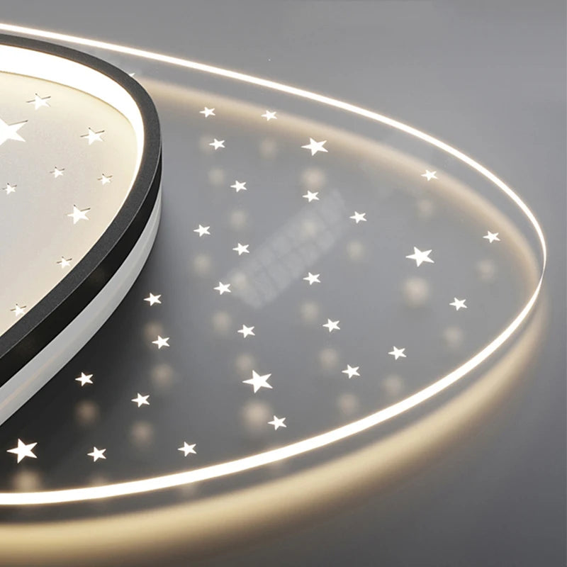 Ceiling light fixture with star patterns on a dark background