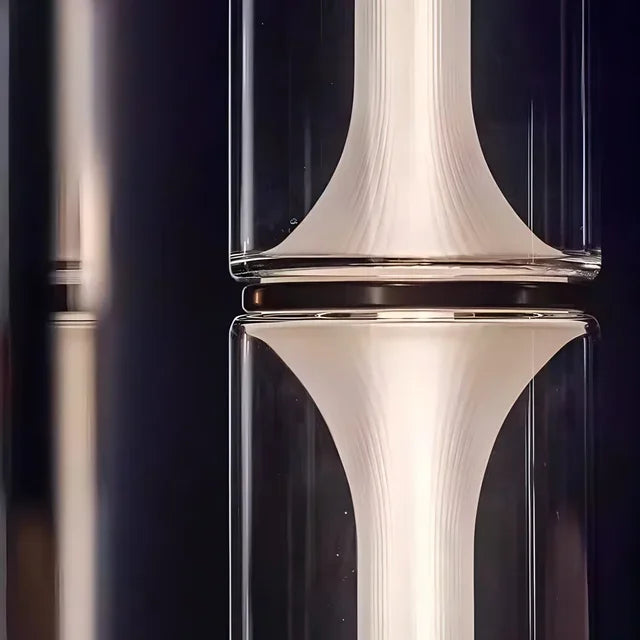 Close-up of a clear glass vase with a white interior against a dark background