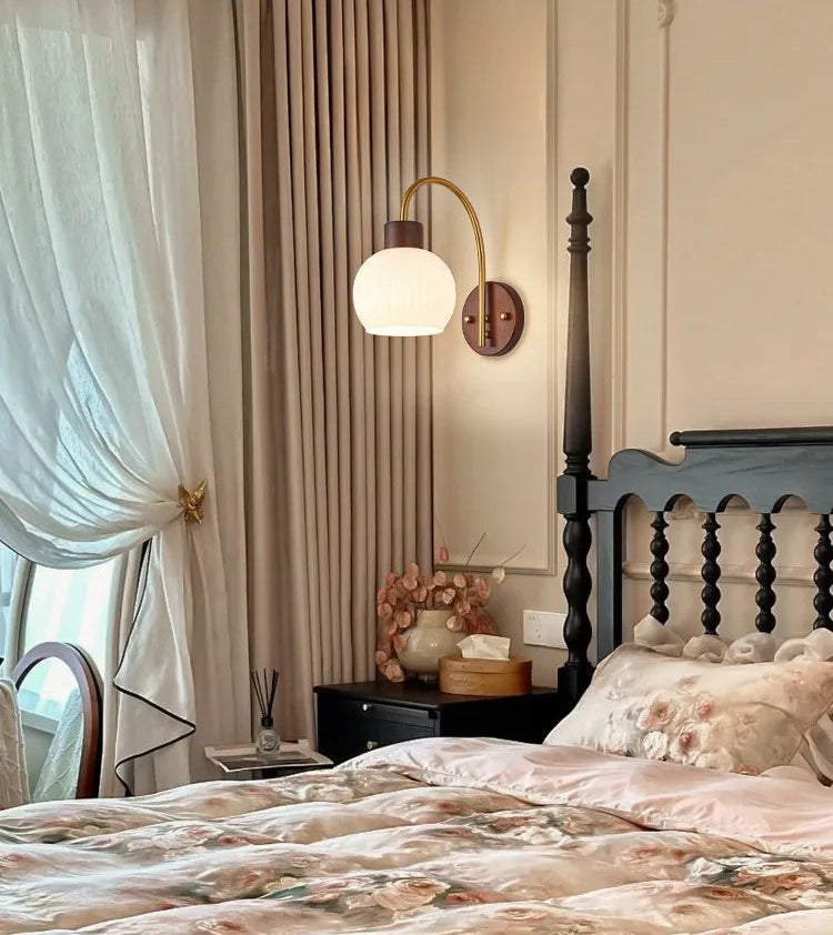 Bedroom with a bed, lamp, and decorative items.