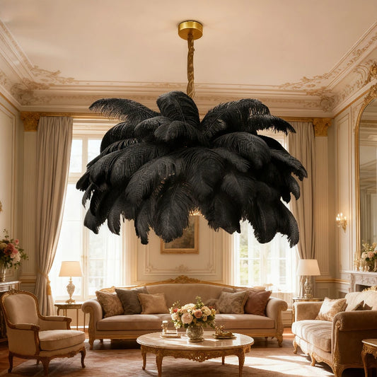 Black feather chandelier with gold accents in a luxurious, classic-style living room with ornate molding.
