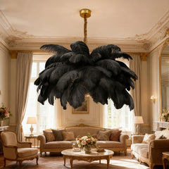 Black feather chandelier with gold accents in a luxurious, classic-style living room with ornate molding.