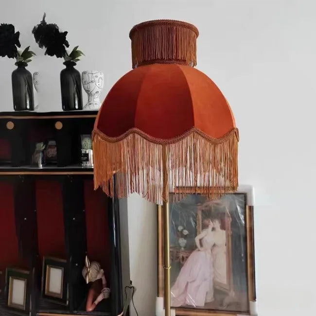 Decorative lamp with fringed shade in a room setting