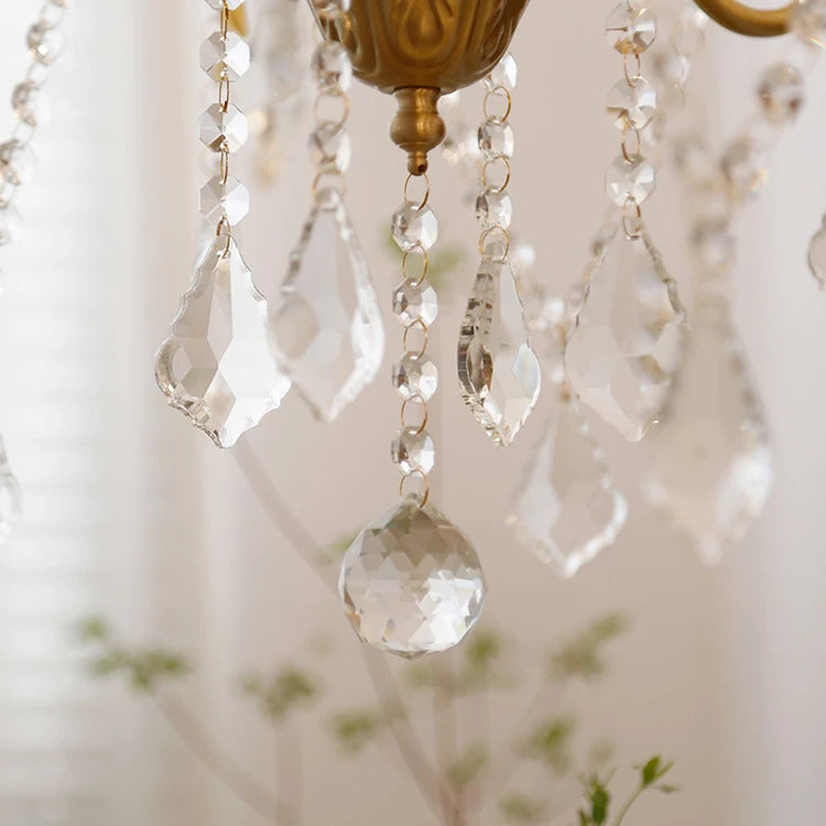 Close-up of a chandelier with crystal beads and gold fixture.