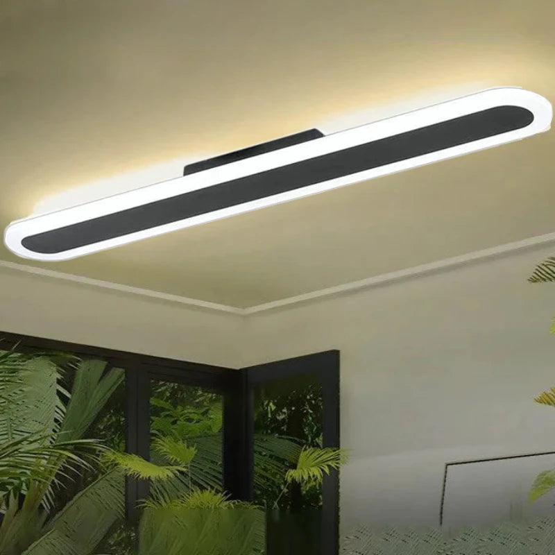 Long, thin, white and black linear ceiling light mounted on a neutral ceiling.