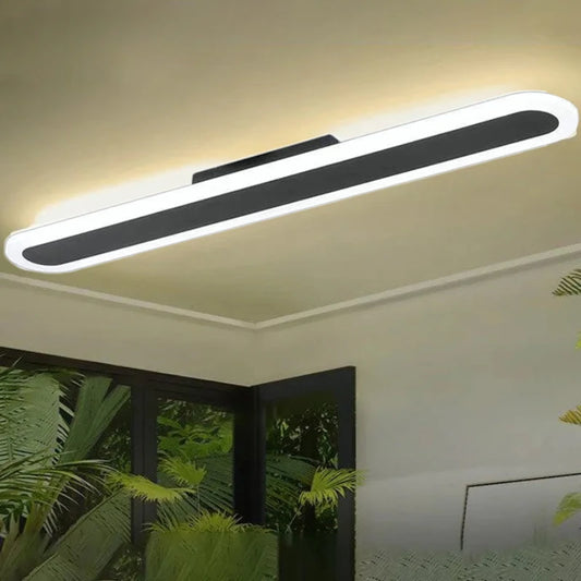 Long, thin, white and black linear ceiling light mounted on a neutral ceiling.