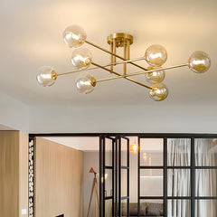 Gold sputnik starburst semi-flush ceiling light installed in a living room with a view of an open doorway