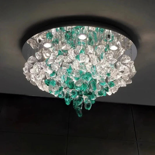 Close-up view of the cascading clear and green crystals on a modern flush mount ceiling light.