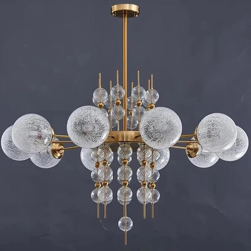 Chandelier with glass bubbles and gold accents on a dark background