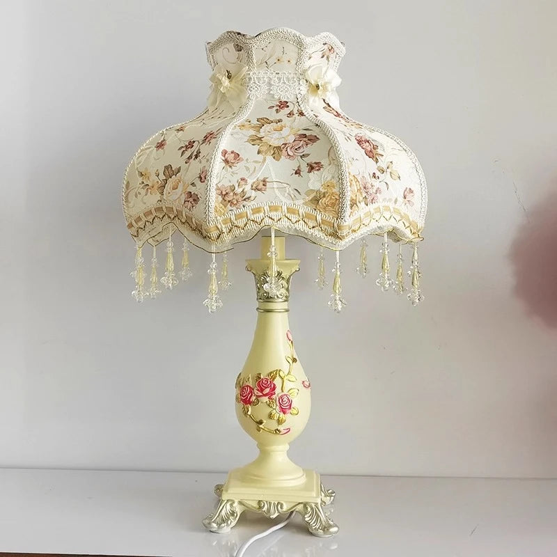 Decorative table lamp with floral design on a plain background