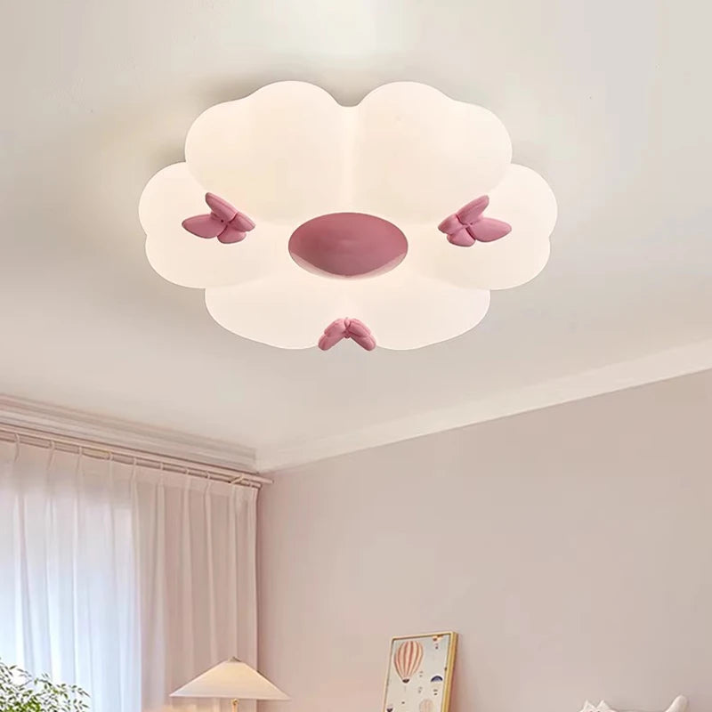 Interior view of a bedroom featuring a white flower cloud semi-flush mount ceiling light with pink butterflies.