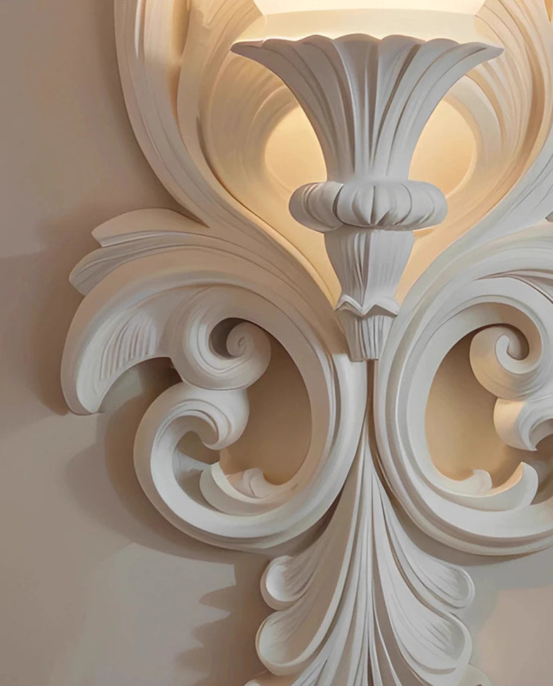Decorative white molding with intricate patterns on a neutral background
