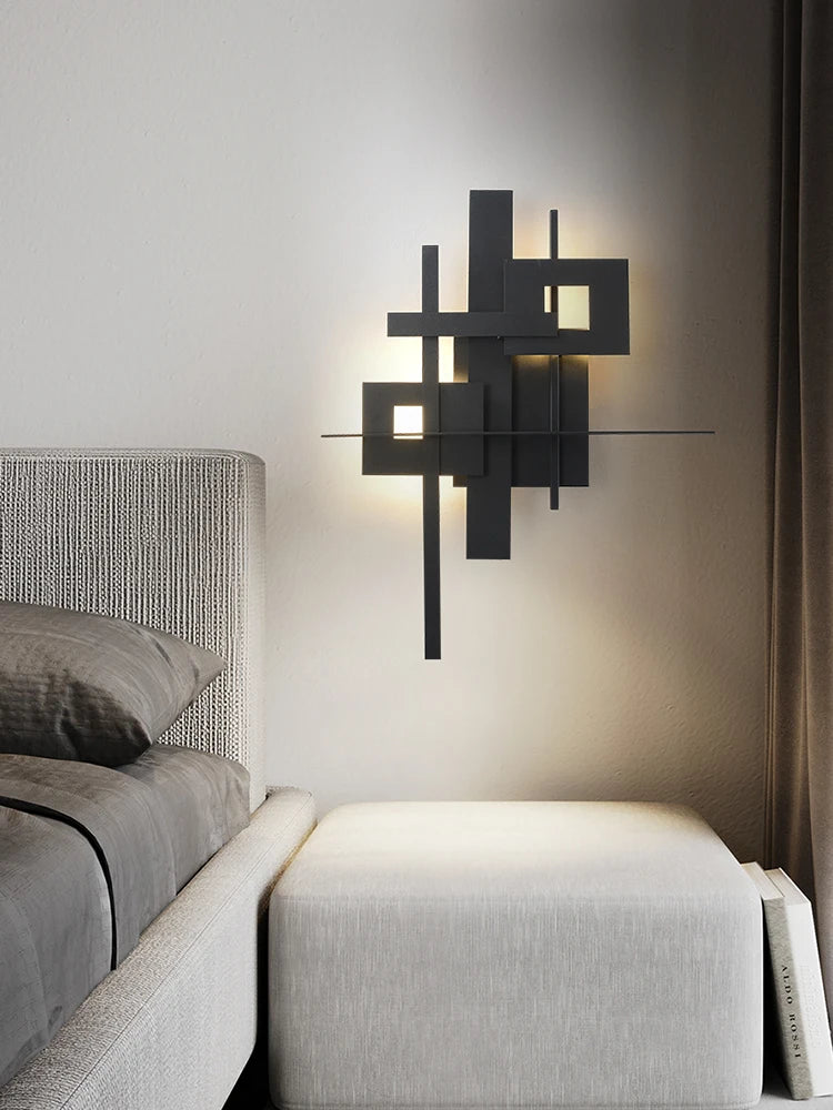 Modern wall sconce above a bed in a bedroom setting