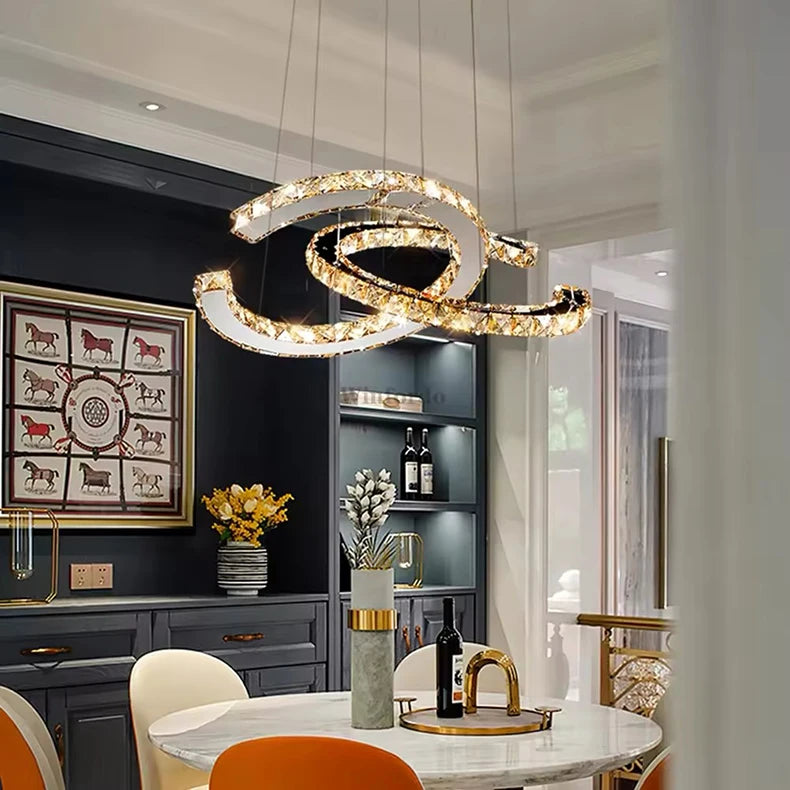 Modern chandelier hanging in a stylish dining room with decor elements.