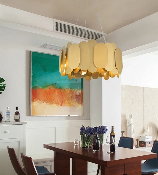 Gold oval link chandelier hanging in a dining room