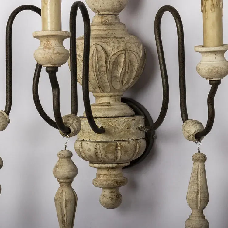Decorative wall sconce with ornate design on a plain background