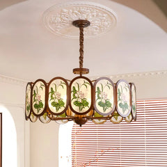 Detailed view of a matte bronze chandelier with oval glass panels depicting lotus flowers.